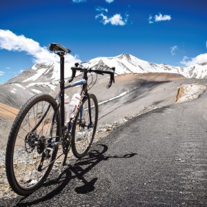 bike-standing-next-to-road-with-mountains-in-background-himalayan-highway-credit-matt-westby